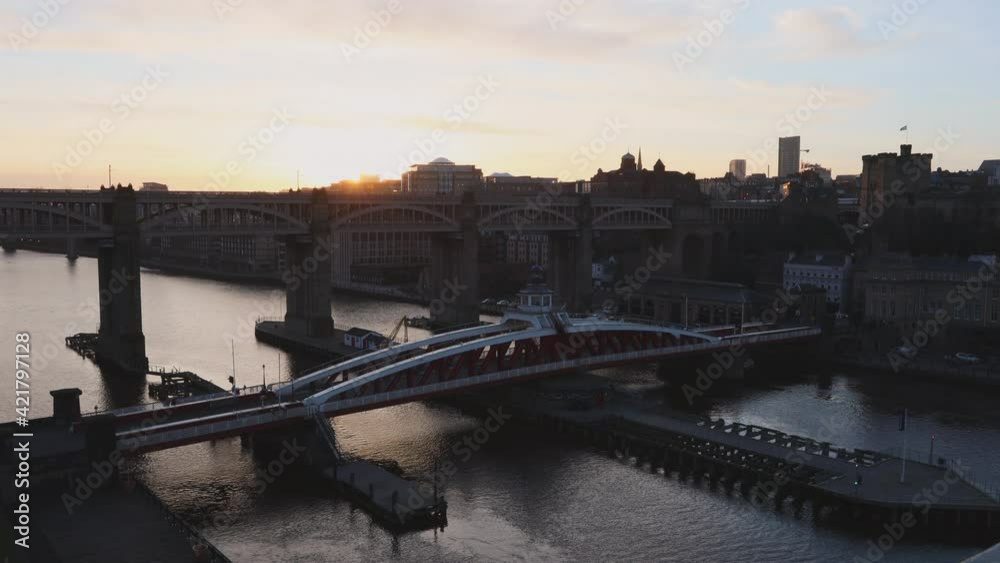 Newcastle upon Tyne UK: 16th March 2021: A static shot of the River Tyne and skyline, with Swing Bridge and High Level Bridge during golden hour Newcastle upon Tyne UK: 16th March 2021: A static shot of the River Tyne and skyline, with Swing Bridge and High Level Bridge during golden hour