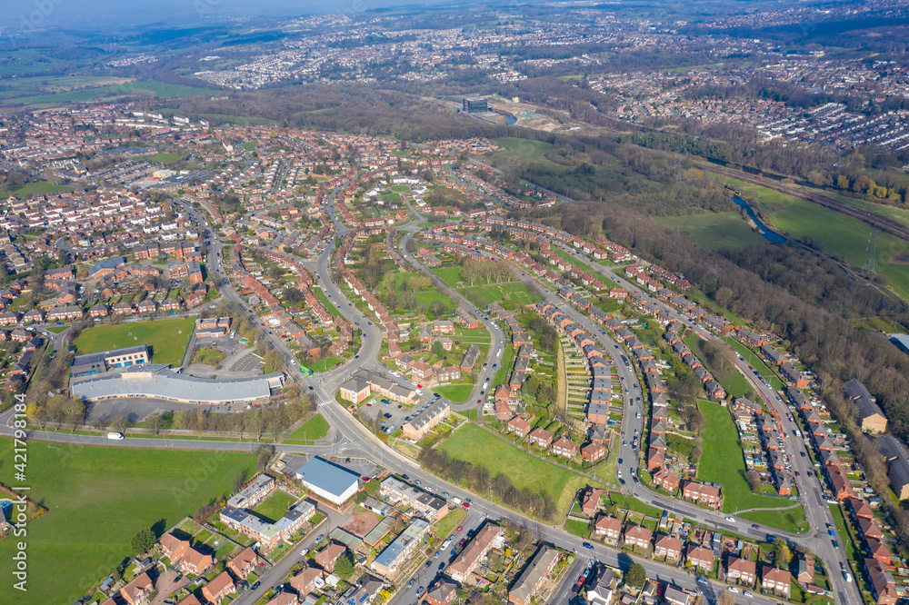 Aerial photo of the town of Kirkstall in Leeds West Yorkshire in the UK, showing a drone view of the village with rows of suburban houses and roads
