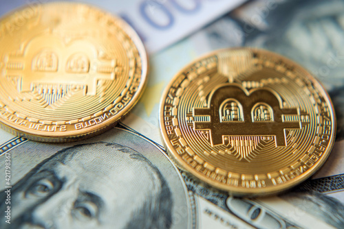 Obraz na płótnie Two bitcoins on denominated dollars and euros in a sunny light (Investment, course change - concept) w salonie