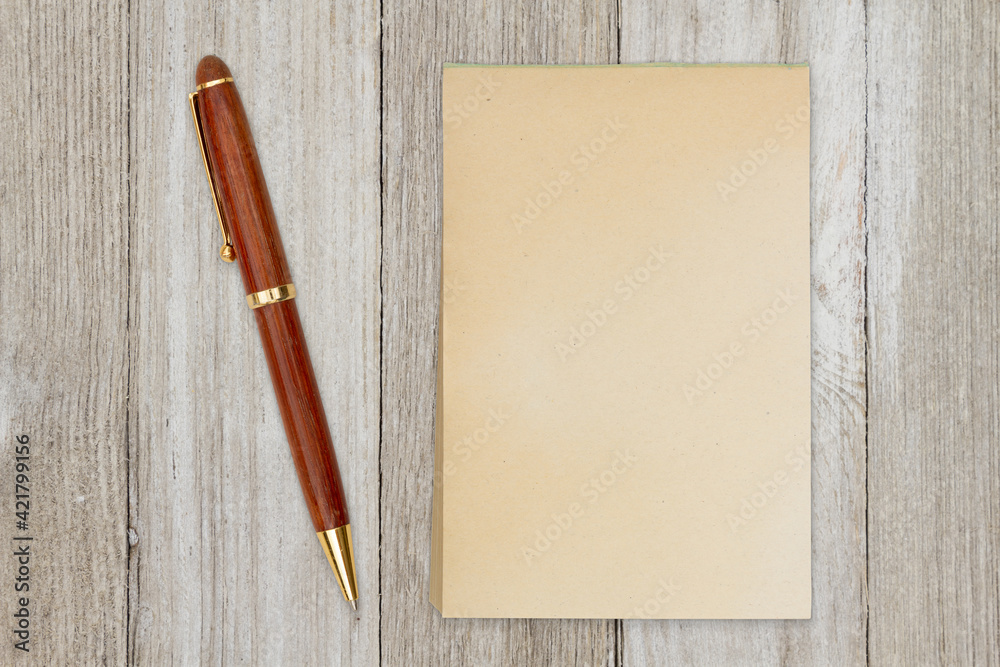 Blank retro old yellowed paper notepad with a pen Blank retro old yellowed paper notepad with a pen