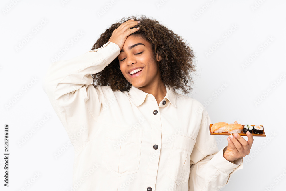 Young African American woman holding sushi isolated on white background has realized something and intending the solution Young African American woman holding sushi isolated on white background has realized something and intending the solution