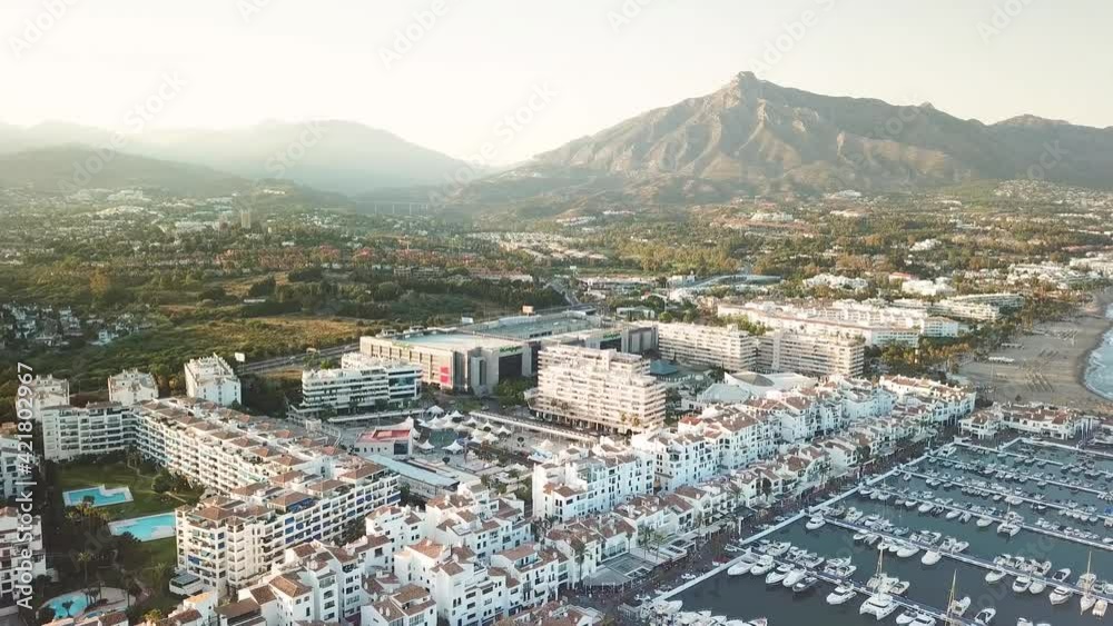 4K aerial perspective of luxury Puerto Banus Bay, exclusive area of Marbella. Famous location for expensive lifestyle , luxury yacht. Drone backward and tilt up. 4K aerial perspective of luxury Puerto Banus Bay, exclusive area of Marbella. Famous location for expensive lifestyle , luxury yacht. Drone backward and tilt up.