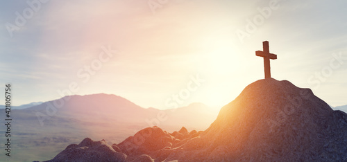Fotografija Cross on mountain peak at sunset christian religion