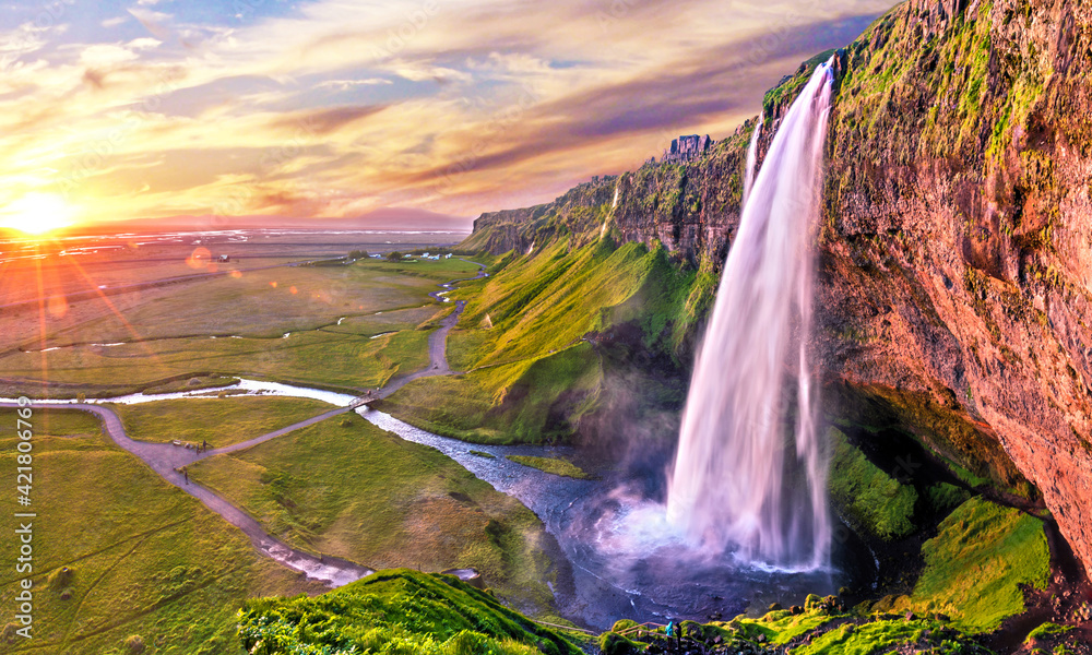 Charming beautiful waterfall Seljalandsfoss in Icelandat sunset. Exotic countries. Amazing places. Popular tourist atraction.