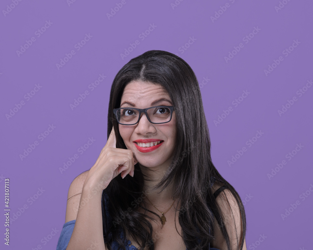 Pensive woman with eyeglasses hand on face.