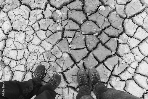to people standing on dry ground, human footpring shoos in dry sandy soil dryness in switzerland