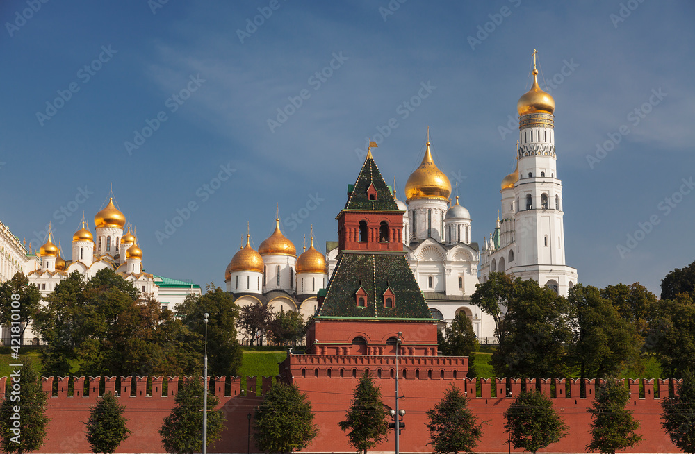 View of the Moscow Kremlin with the Grand Kremlin Palace, cathedrals and the bell tower of Ivan the Great on a sunny summer day. Russia