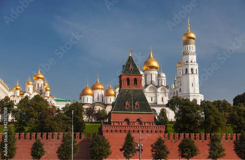 View of the Moscow Kremlin with the Grand Kremlin Palace, cathedrals and the bell tower of Ivan the Great on a sunny summer day. Russia