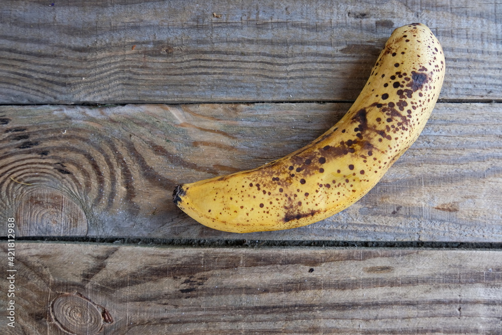 Overripe banana with dark spots on the skin . Ugly fruit. Buying ...