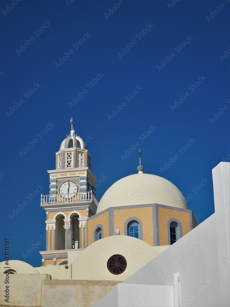 Whitewashed walls, tower and blue dome of one of the many churches on Santorini Whitewashed walls, tower and blue dome of one of the many churches on Santorini