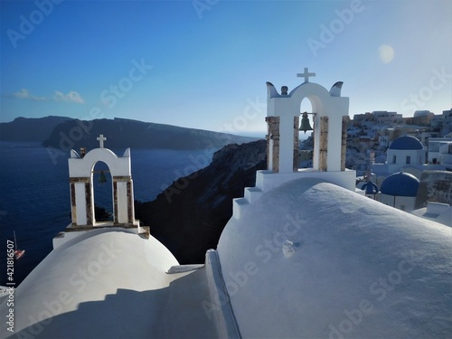 View over Santorini's bell towers to the sea and the blue and white domed town below
