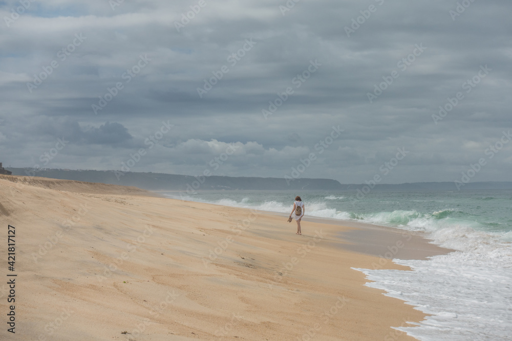 girl walking on an empty beach