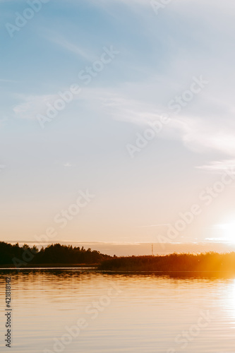 Sunset over the Lielupe river in Latvia during warm summer evening © Janis Eglins