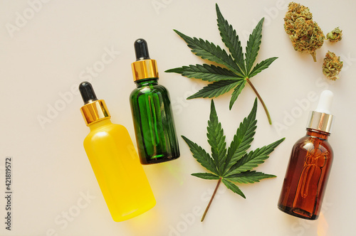 Cannabis leaves, cbd oil, blooming buds. Marihuana extract in cosmetology. Flat lay, white background. Home relaxation, spa recreation, pastime therapy.