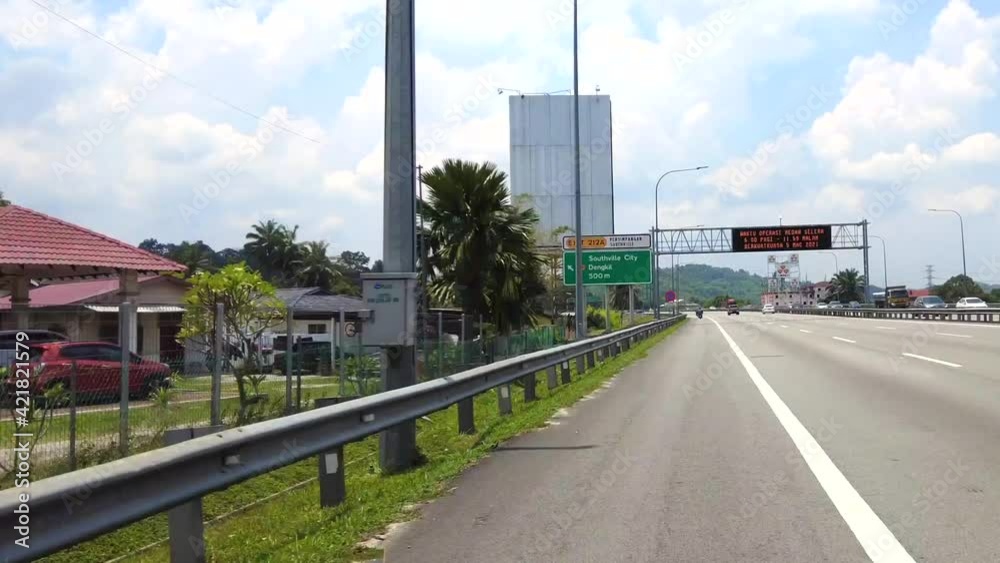 Kuala Lumpur, Malaysia - March 20, 2021 Point of view riding a motorcycle in North-South highway exiting Putra Mahkota. Hyperlapsed. Kuala Lumpur, Malaysia - March 20, 2021 Point of view riding a motorcycle in North-South highway exiting Putra Mahkota. Hyperlapsed.