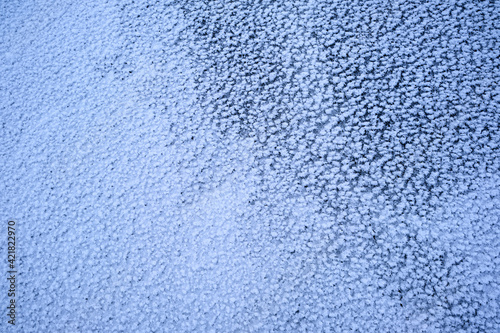 the texture of ice with snow in winter on the street