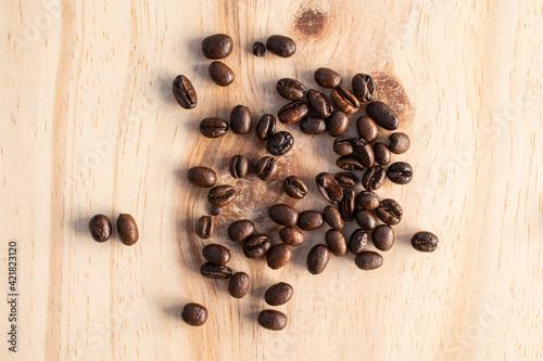 Few coffee bean on wooden background