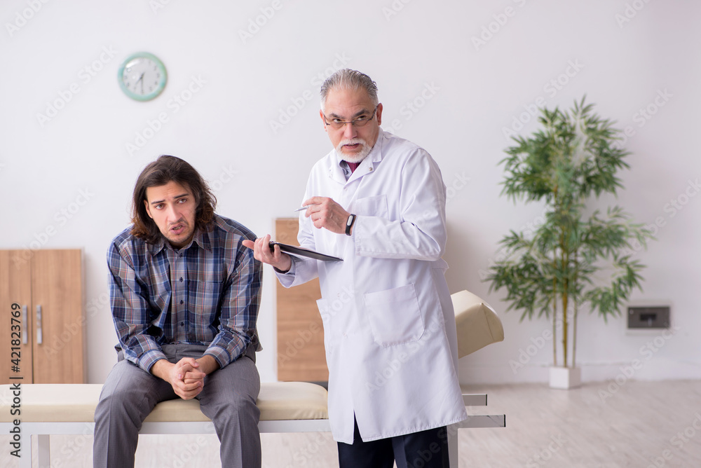 Fototapeta premium Young male patient visiting experienced doctor psychiatrist