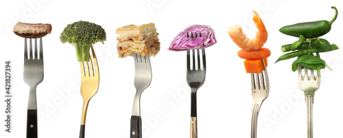 Konstfotografi Different food impaled on forks against white background