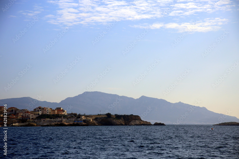 Silhouette of the coast with mountains in the background, viewed from the sea, Parc National des Calanques, Marseille, France Silhouette of the coast with mountains in the background, viewed from the sea, Parc National des Calanques, Marseille, France