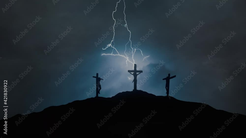 Silhouettes of three crosses on top of a hill in the stormy night. Concept of the Crucifixion of Christ.