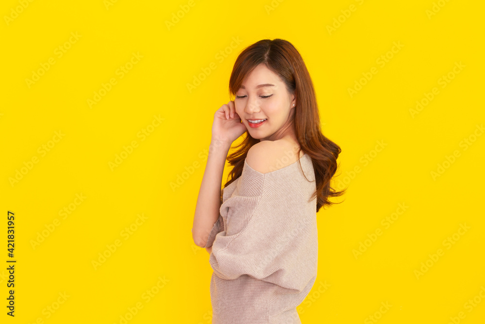 Beautiful Asian young woman's portrait on bright yellow background Beautiful Asian young woman's portrait on bright yellow background