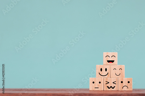 Smiley face happy symbol on wooden block , Services and Customer satisfaction survey concept