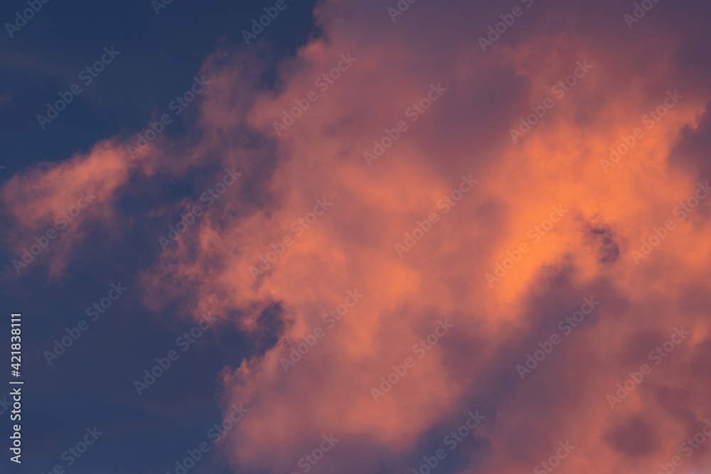 Red orange evening sky with clouds, large background image with moody evening colors
