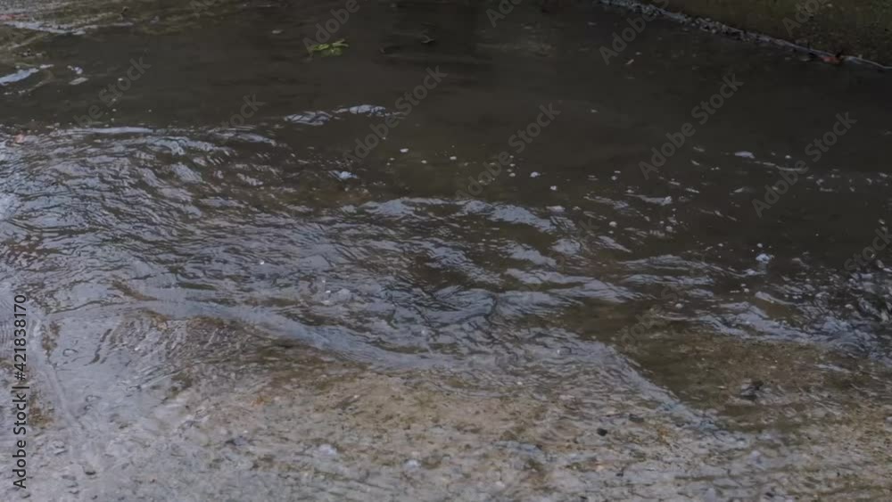 Run through puddle in yellow rubber boots and enjoy wet spring weather like little child. Video of legs without persons face. Enjoy and walk in rain. Run through puddle in yellow rubber boots and enjoy wet spring weather like little child. Video of legs without persons face. Enjoy and walk in rain.