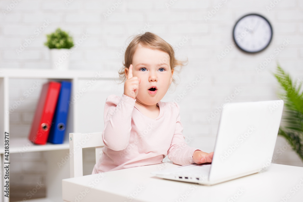 amazed or surprised little girl using laptop at home or in class room amazed or surprised little girl using laptop at home or in class room