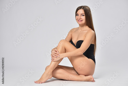 Beautiful woman after depilation on a gray background, Stock Photo