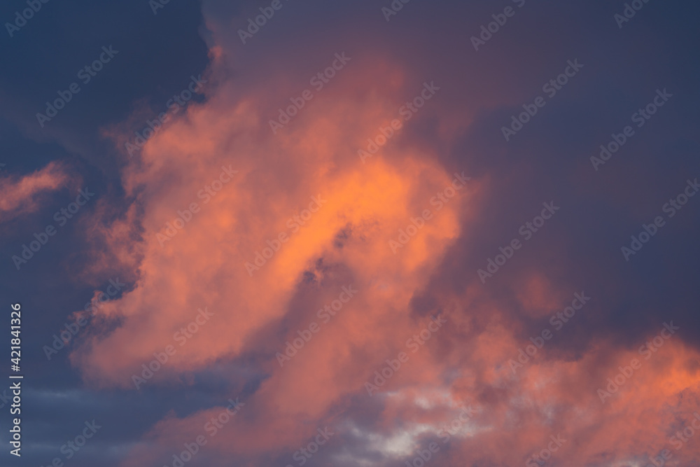 Red orange evening sky with clouds, large background image with moody evening colors Red orange evening sky with clouds, large background image with moody evening colors