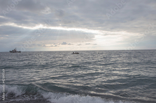 Fisherman boat on the sea so far for thire life with silhouette style background