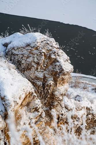 rock stone snow. View from the top to the cliffs. Russia's nature. first snow, river white snow, morning, height. beauty, wildlife
