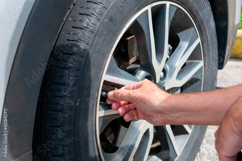 Man calibrating car tire - closeup on hand © Lais