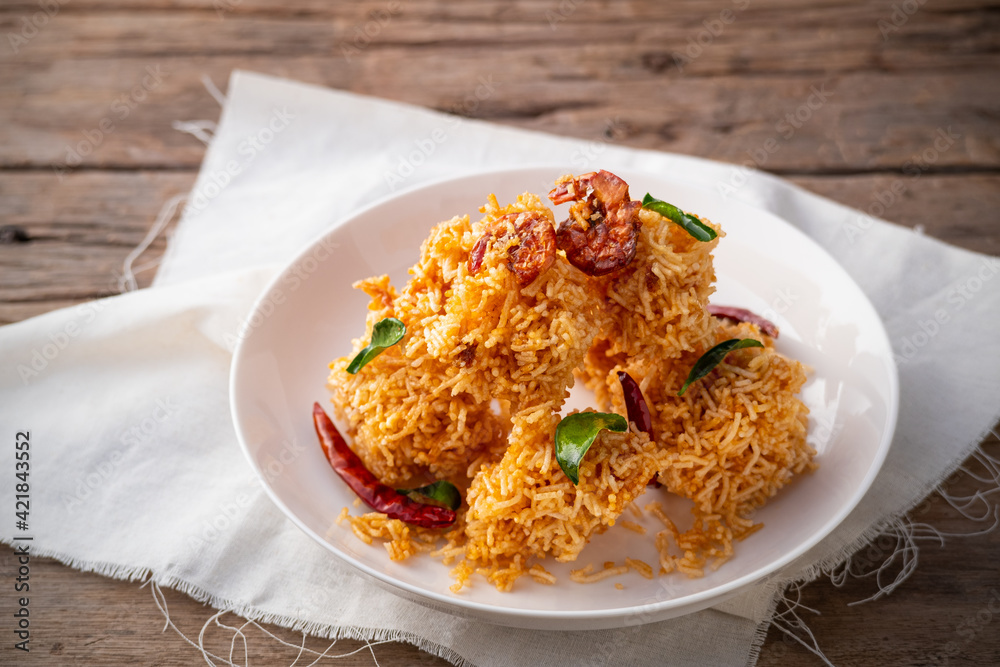 Thai dessert, Mixed Crispy Rice Noodle (Mee Krob) in white plate on wood background