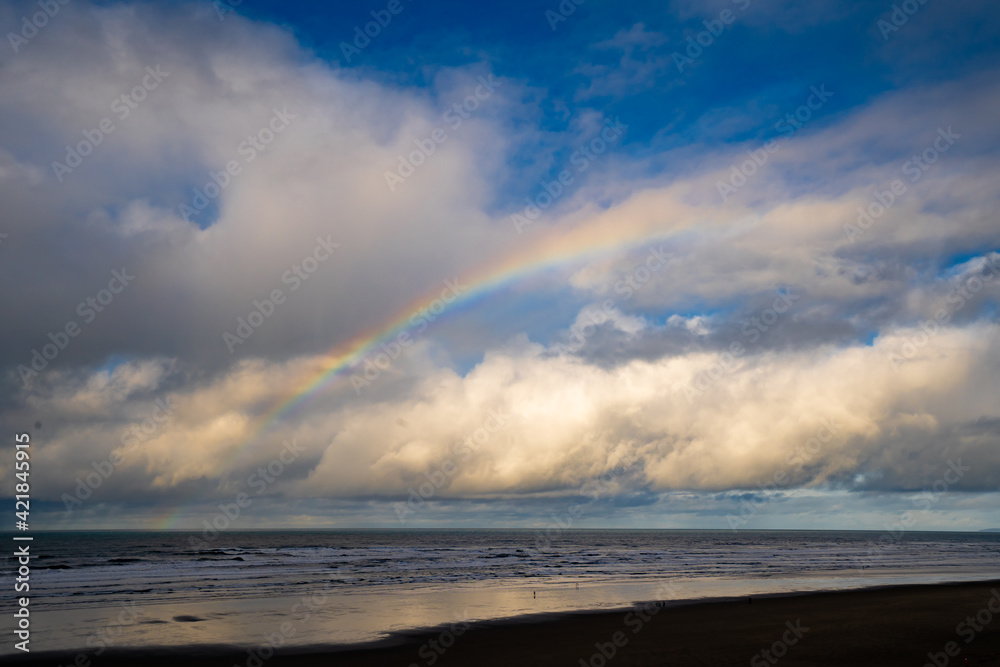Fototapeta premium The beach at Seaside on the Oregon coast with clouds and rainbow