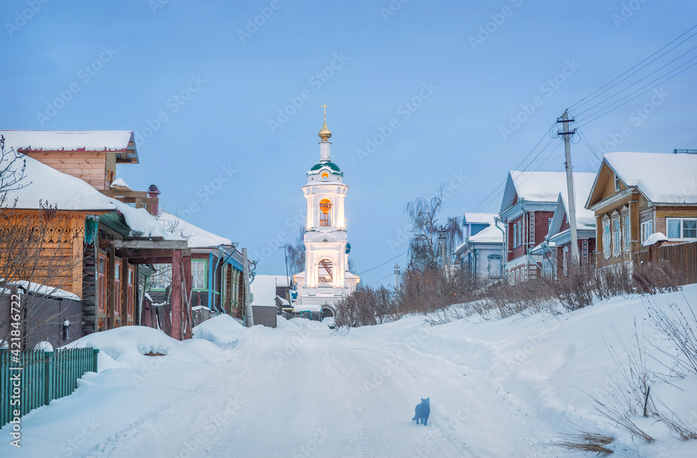 A cat in an alley in Plyos and the bell tower of the Varvarinskaya church