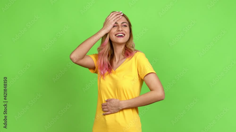 Young blonde woman keeping the arms crossed while smiling over isolated background on green screen chroma key Young blonde woman keeping the arms crossed while smiling over isolated background on green screen chroma key