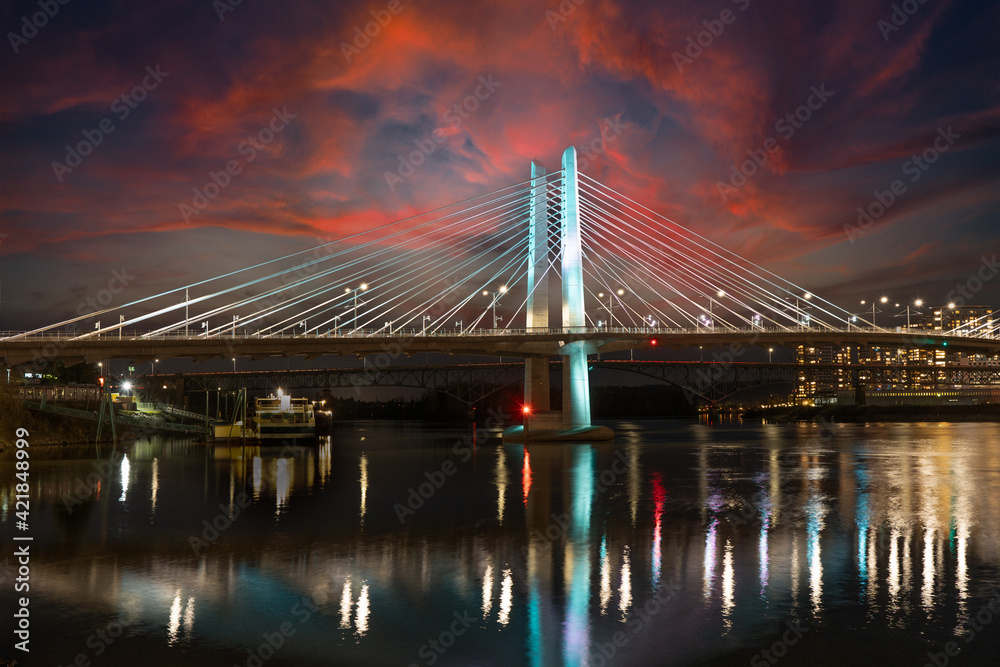 Looking south at sunset at the cable stayed Tilikum bridge over the Willamette River in Portland Oregon