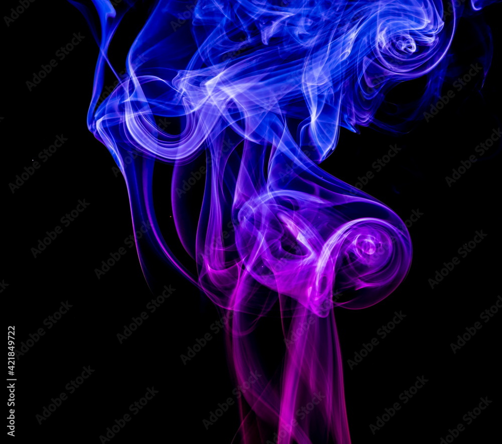 Naklejka premium Colored smoke on black background