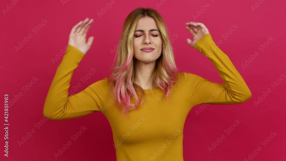 Young blonde woman covering both ears with hands. Frustrated expression over isolated background Young blonde woman covering both ears with hands. Frustrated expression over isolated background