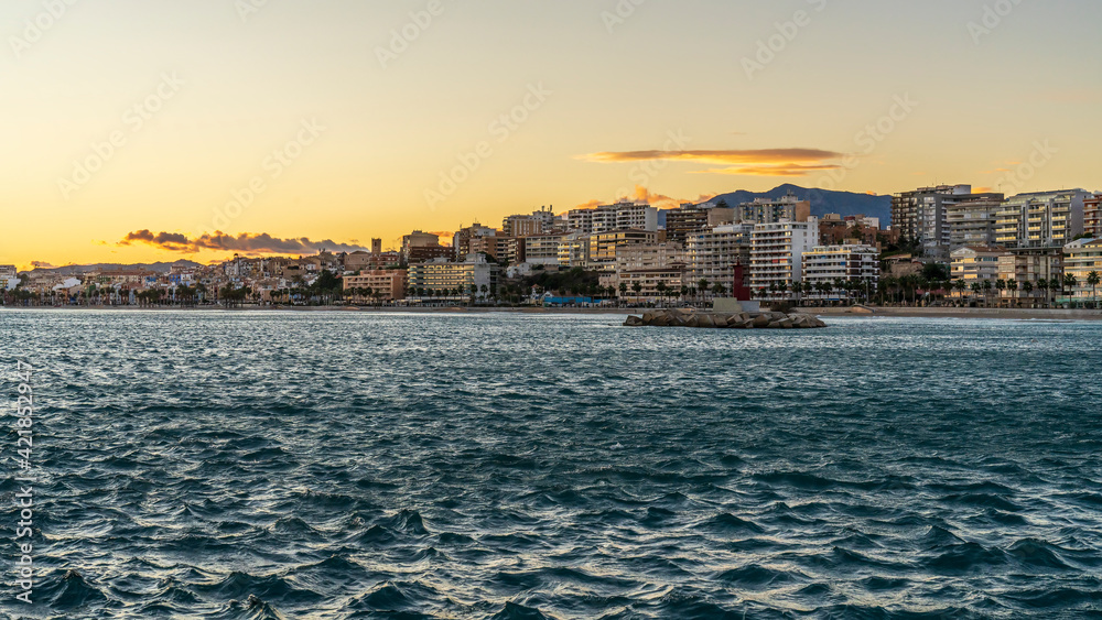 View of the town of Villajoyosa from its fishing port at sunset.
