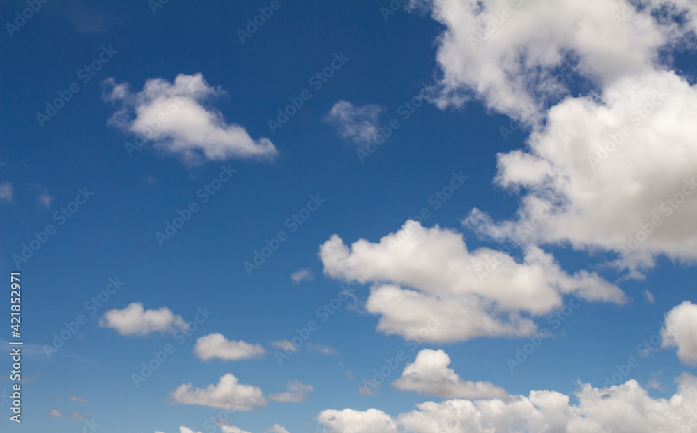 Obraz premium Beautiful white cotton-like clouds. White cloud cumulus. Water in the form of steam in the sky