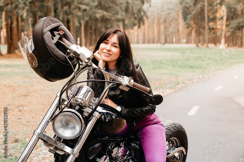 beautiful brunette riding a motorcycle in the park © vilma3000