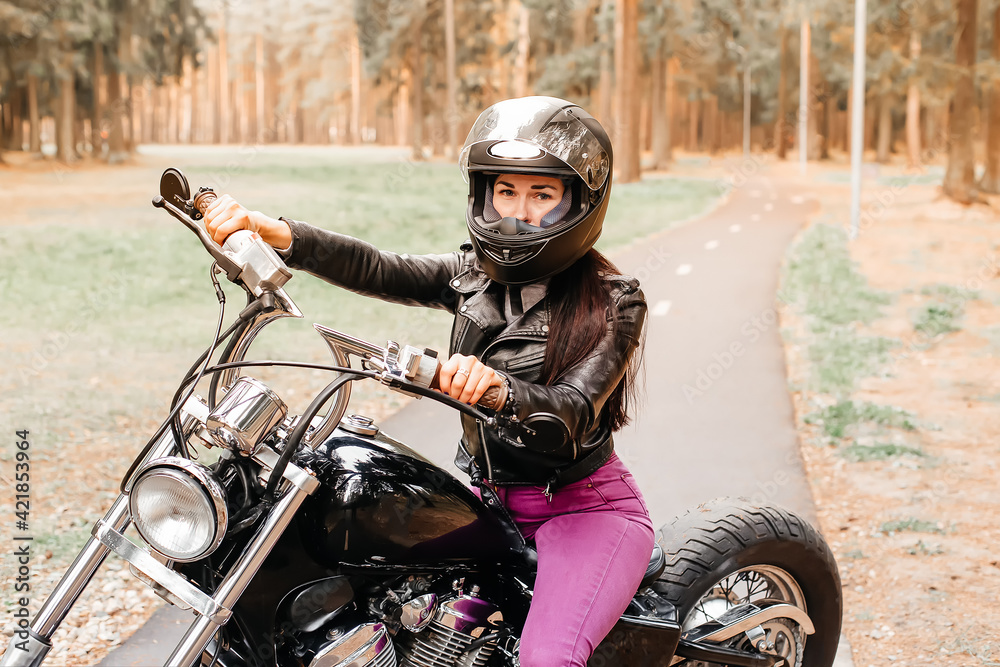 beautiful brunette riding a motorcycle in the park beautiful brunette riding a motorcycle in the park