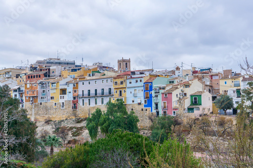 View of the colorful houses of the town of Villajoyosa in a cloudy day.