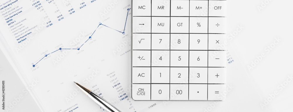 Calculator on financial statement and balance sheeet on desk of auditor. Concept of accounting and audit business. Calculator on financial statement and balance sheeet on desk of auditor. Concept of accounting and audit business.