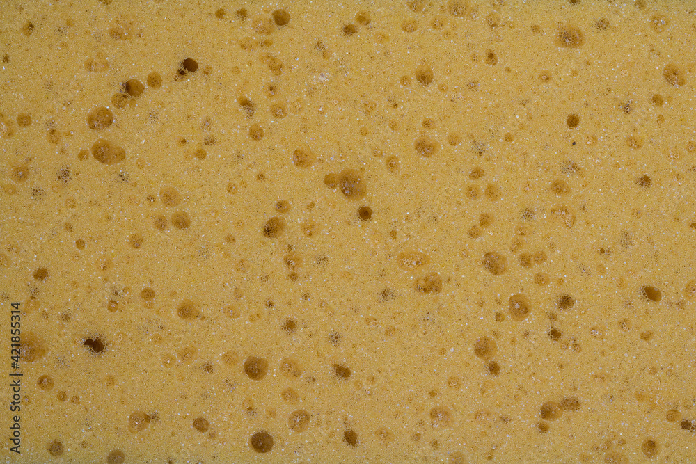 Full frame of yellow porous sponge texture as a background