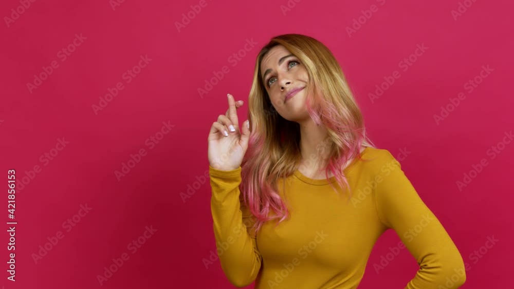 Young blonde woman with fingers crossing and wishing the best. Making a wish over isolated background Young blonde woman with fingers crossing and wishing the best. Making a wish over isolated background